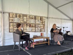 Photo of Jacqx Melilli reading an excerpt from her novel When The Glitter Fades at the Bellingen Readers and Writers Festival